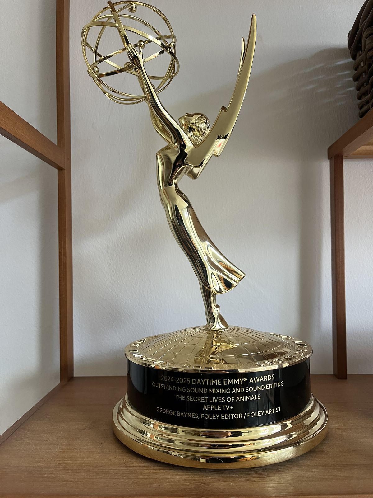 George Baynes's Daytime Emmy statuette for The Secret Lives of Animals on a wooden shelf