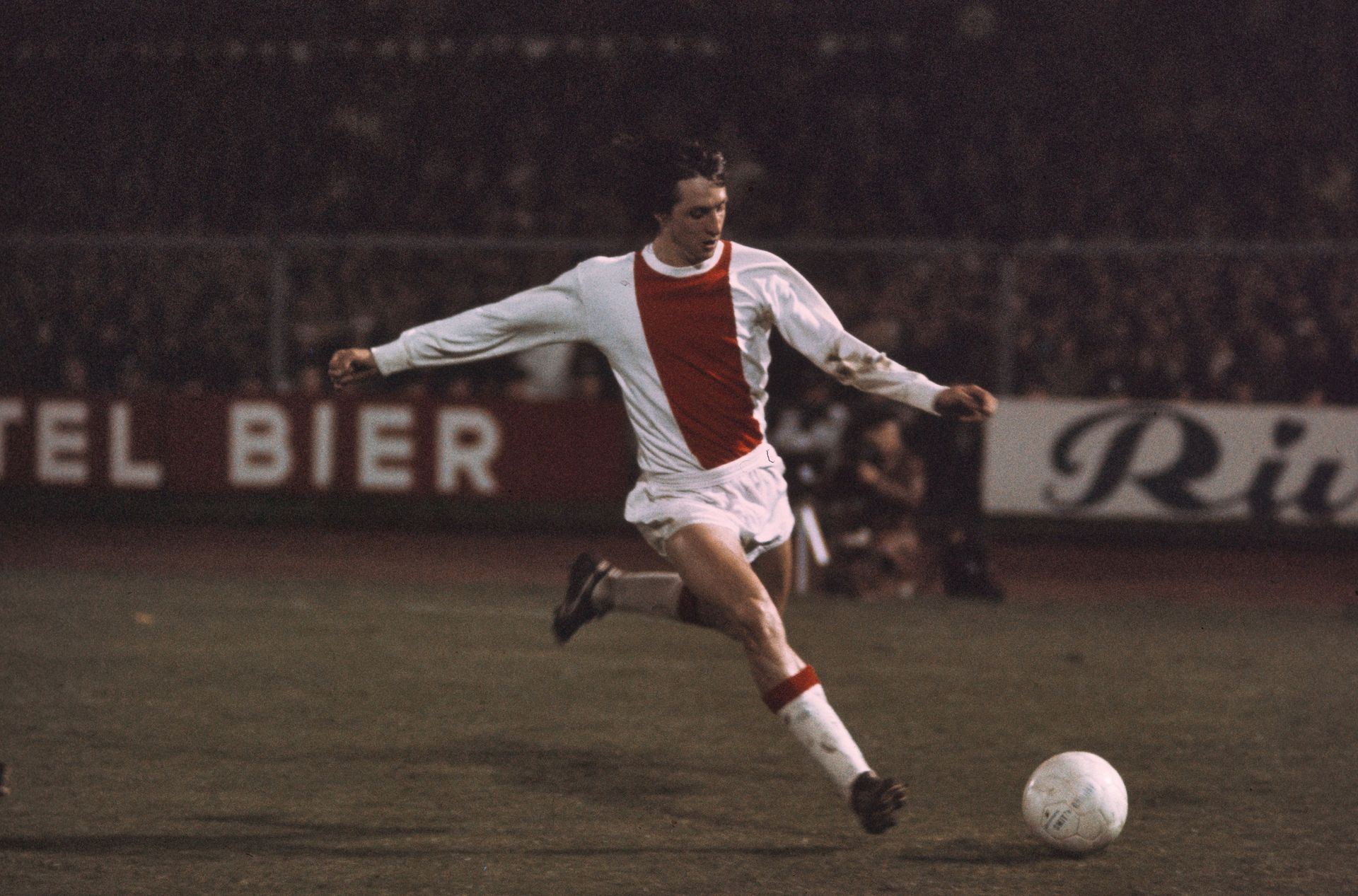 Cruyff: Johan Cruyff in an Ajax shirt striking the ball under floodlights